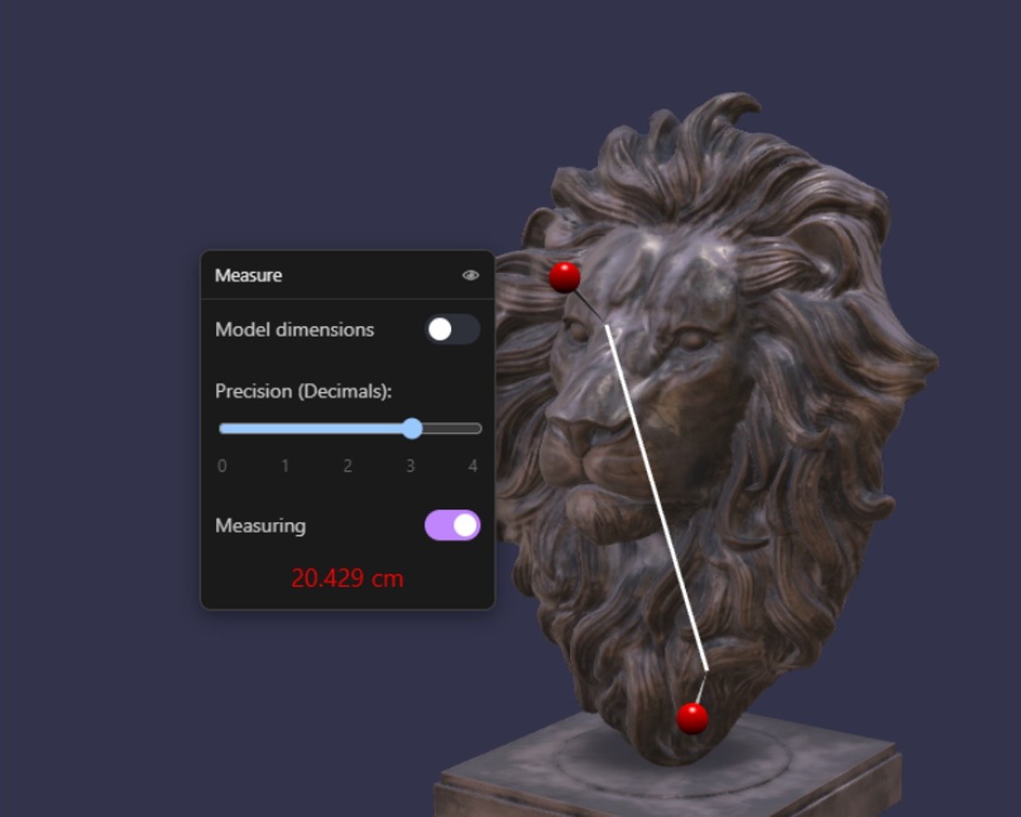 Measurement tool showing two pins connected by a line on a lion-head artefact with the measured distance displayed